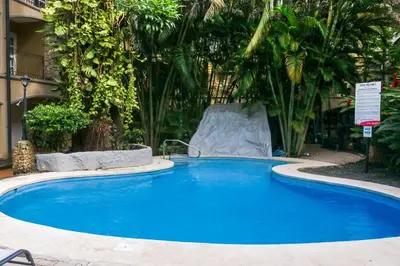 a large blue swimming pool with a water slide at Villa Verde I - 3 in Tamarindo