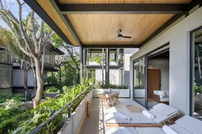 an outdoor patio with a table and chairs at QUIN Surf Residence Nosara in Nosara