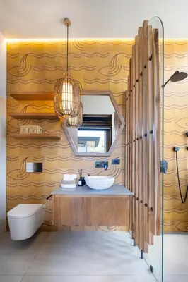 a bathroom with a sink and a toilet and a mirror at QUIN Surf Residence Nosara in Nosara