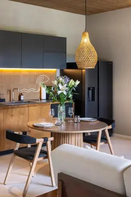 a kitchen with a table with a vase of flowers at QUIN Surf Residence Nosara in Nosara
