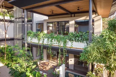 an external view of a house with plants at QUIN Surf Residence Nosara in Nosara
