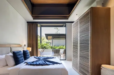 a bedroom with a large bed and a balcony at QUIN Surf Residence Nosara in Nosara