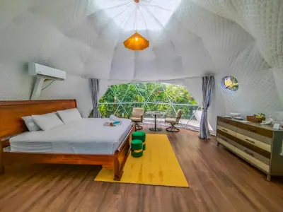 a bedroom with a bed in a tent at Palo Alto Glamping Hotel in Quesada