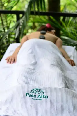 a woman laying on top of a bed at Palo Alto Glamping Hotel in Quesada