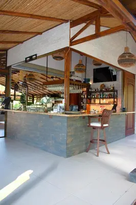 a bar with a chair in front of it at Palo Alto Glamping Hotel in Quesada