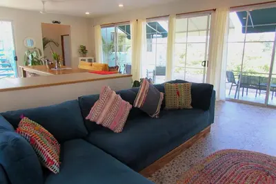 a blue couch with pillows on it in a living room at Boutique Tropical Retreat, Sleeps 10, Perfect for Friends and Fams in Sámara