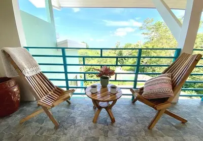 two chairs and a coffee table on a balcony at Boutique Tropical Retreat, Sleeps 10, Perfect for Friends and Fams in Sámara