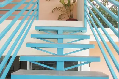 a set of blue stairs with a potted plant at Boutique Tropical Retreat, Sleeps 10, Perfect for Friends and Fams in Sámara
