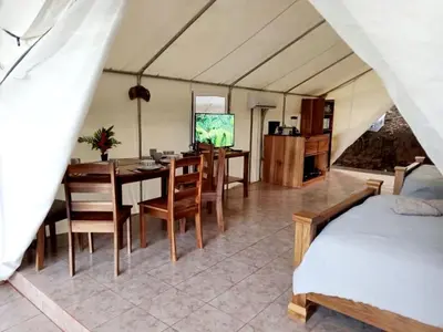 a room with a dining table and a dining room at Volcano Tenorio Glamping Ranch - 3 Tents in Rio Celeste
