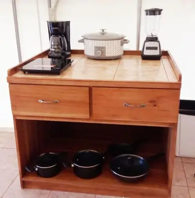 a wooden cabinet with pots and pans on it at Volcano Tenorio Glamping Ranch - 3 Tents in Rio Celeste