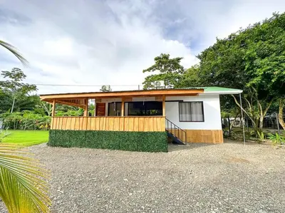 a small house with a porch on top of it at Casa Garza, con a/c y wifi in Quepos