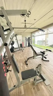 a gym with two treadmills and a treadmill at Luxury NEW Apt -24/7 sec- 10 min from SJO Airport in Heredia