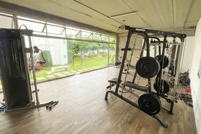 a gym with two treadmills and a large window at Luxury NEW Apt -24/7 sec- 10 min from SJO Airport in Heredia