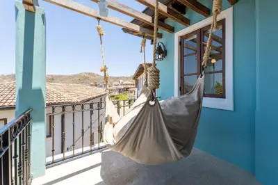 a hammock hanging on a balcony of a house at Casa De Los Sueños- 5 Bedroom Home At Las Catalinas in Playa Danta