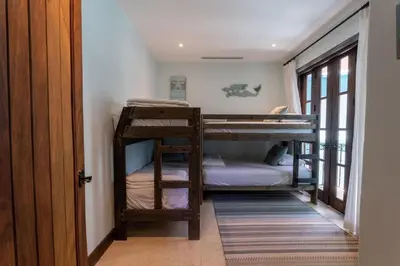 a hallway with two bunk beds in a room at Casa De Los Sueños- 5 Bedroom Home At Las Catalinas in Playa Danta