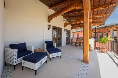 a patio with chairs and tables on a balcony at 4 Bedroom Complex At Las Catalinas in Playa Danta