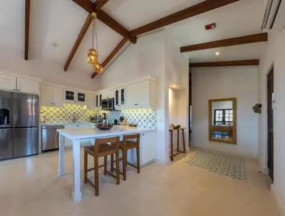 a kitchen with a white table and some chairs at 4 Bedroom Complex At Las Catalinas in Playa Danta