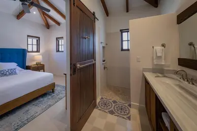 a bedroom with a bed and a bathroom with a sink at 4 Bedroom Complex At Las Catalinas in Playa Danta