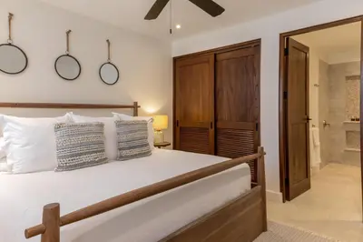 a bedroom with a large bed and a bathroom at 4 Bedroom Complex At Las Catalinas in Playa Danta