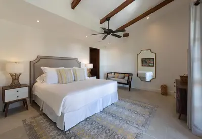 a bedroom with a white bed and a ceiling fan at 4 Bedroom Complex At Las Catalinas in Playa Danta
