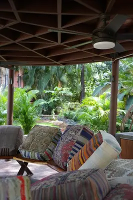 a group of couches sitting under a porch at Balu Retreat Center in Playa Junquillal