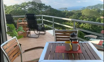 a balcony with a table with two cups on it at Buena Vista Coco in Coco