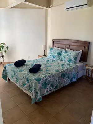 a bedroom with a bed with two pillows on it at Buena Vista Coco in Coco