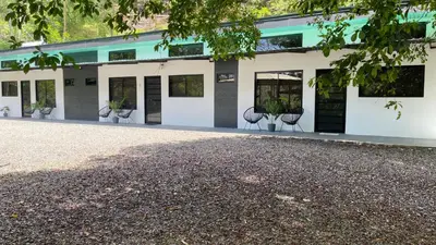 a building with chairs in front of it at Villas Anna Bertha 2 noches minimo in San Isidro