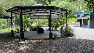 a gazebo in the middle of a garden at Villas Anna Bertha 2 noches minimo in San Isidro