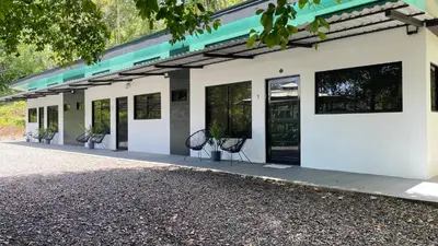 a white building with two chairs in front of it at Villas Anna Bertha 2 noches minimo in San Isidro