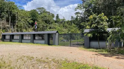 a black and white building with a fence at Villas Anna Bertha 2 noches minimo in San Isidro