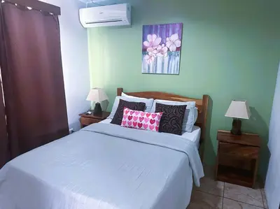 a bedroom with a white bed with pillows on it at 2nd floor A/C, Wifi, Fully equipped apartment in Fortuna