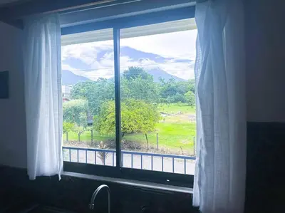 a window with a view of a field and mountains at 2nd floor A/C, Wifi, Fully equipped apartment in Fortuna