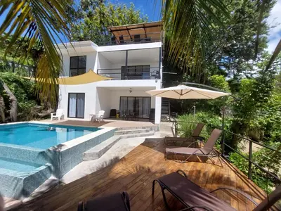 a villa with a swimming pool and a house at Sunset Villa - Upper Poolside in Sámara