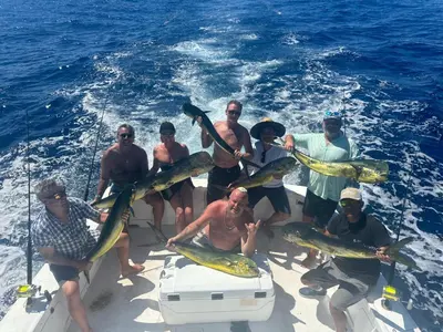 a group of people on a boat holding fish at Sunset Villa - Upper Poolside in Sámara
