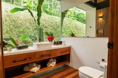 a bathroom with a sink and a mirror at Villa Morpho - Luxury Jungle House at Ecolirios Green Community in Guácimo