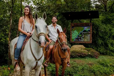 a man and a woman riding on a horse at Villa Morpho - Luxury Jungle House at Ecolirios Green Community in Guácimo