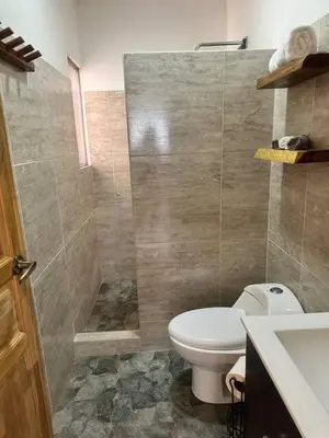 a bathroom with a toilet and a shower and a sink at Sunset Villa - Stunning Poolside in Sámara