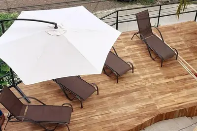 a table and chairs with an umbrella on a patio at Sunset Villa - Stunning Poolside in Sámara