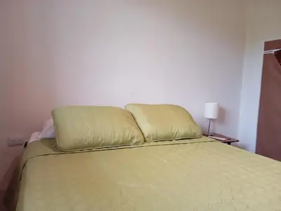 a bed with two pillows on top of it at Apartamento la paz N°2 in Liberia