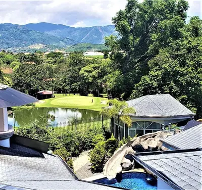an aerial view of a house with a golf course at Alameda Cariari Boutique Hotel in San José