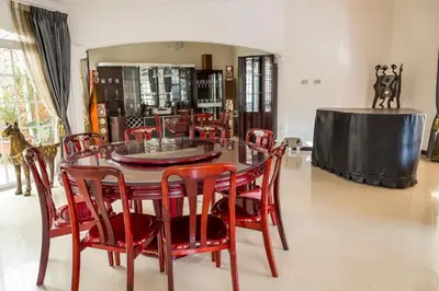 a dining room with a table and red chairs at Alameda Cariari Boutique Hotel in San José