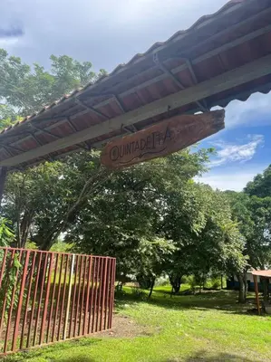 a sign for a park with a fence and trees at La Quinta de Ita in Morales