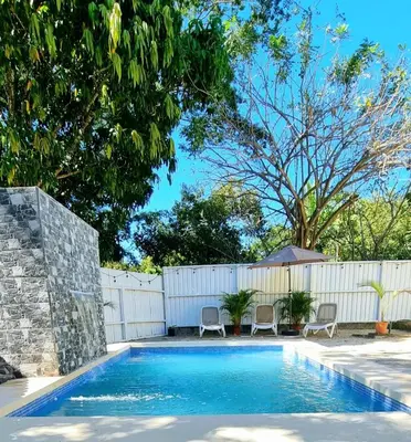 a swimming pool in a backyard with a white fence at La Quinta de Ita in Morales
