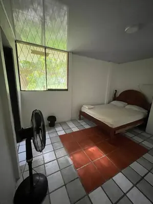 a small bedroom with a bed and a window at La Quinta de Ita in Morales