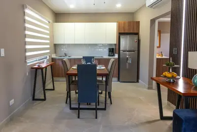 a kitchen and dining room with a table and chairs at Sueño al Mar Residence & Hotel in Potrero