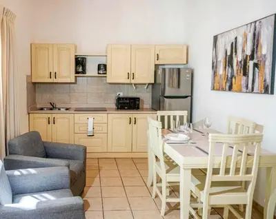 a kitchen with a table and a dining room at Sueño al Mar Residence & Hotel in Potrero