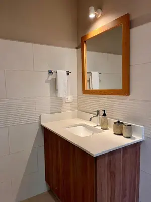 a bathroom with a sink and a mirror at Sueño al Mar Residence & Hotel in Potrero