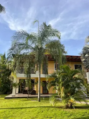 a palm tree in front of a building at Sueño al Mar Residence & Hotel in Potrero