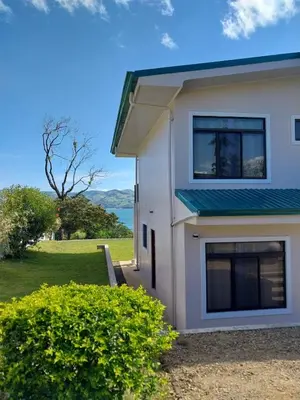 a white house with a view of the ocean at Arenal Vistas del Paraiso in Nuevo Arenal